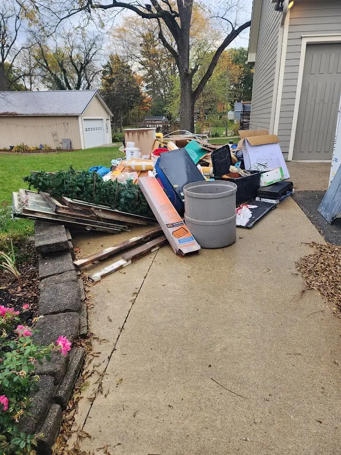 Dumpster being loaded with debris for Estate Cleanout Dumpster Rental in Deerfield